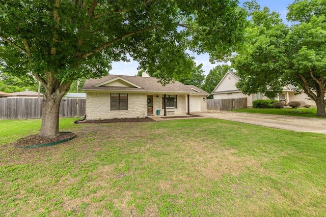 506 S Main St, Thrall, TX 76578 - ranch-style house with concrete driveway, a garage, stone siding, and covered porch