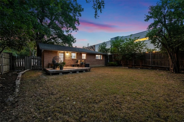 1715 Bluebonnet Ln, Austin, TX 78704 - back of property at dusk with a wooden deck and brick siding