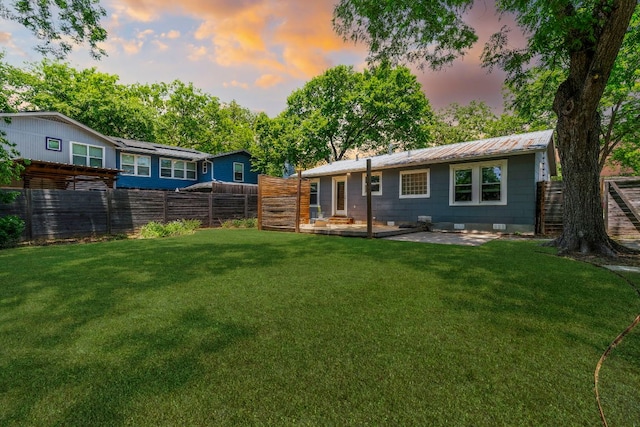 1505 Palo Duro Rd, Austin, TX 78757 - back of property at dusk featuring a patio, crawl space, and metal roof