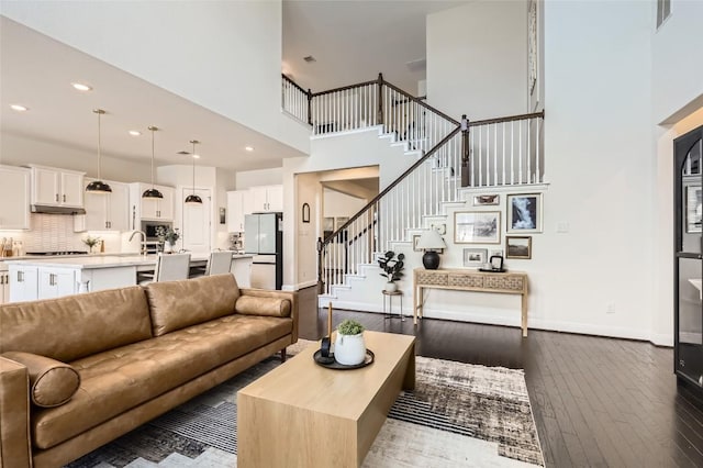 4116 Brean Down Rd, Pflugerville, TX 78660 - living room featuring a high ceiling, stairway, hardwood / wood-style flooring, baseboards, and recessed lighting