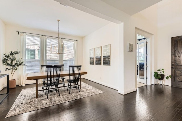 4116 Brean Down Rd, Pflugerville, TX 78660 - dining room featuring dark wood-type flooring, baseboards, and a chandelier