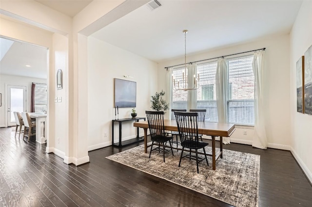 4116 Brean Down Rd, Pflugerville, TX 78660 - dining space with dark wood-style flooring, baseboards, and a chandelier