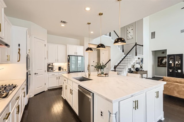 4116 Brean Down Rd, Pflugerville, TX 78660 - kitchen featuring a sink, appliances with stainless steel finishes, dark wood-style flooring, white cabinets, and recessed lighting