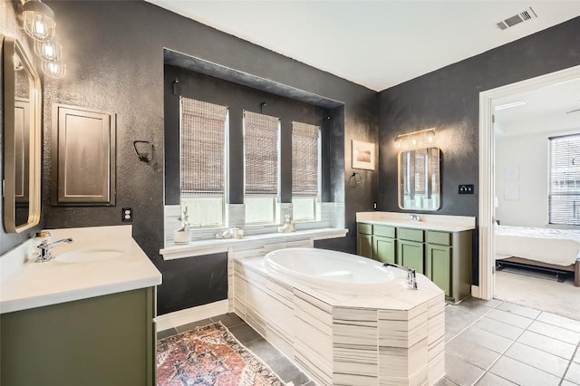 4116 Brean Down Rd, Pflugerville, TX 78660 - full bath featuring tile patterned floors, a garden tub, two vanities, ensuite bath, and a textured wall