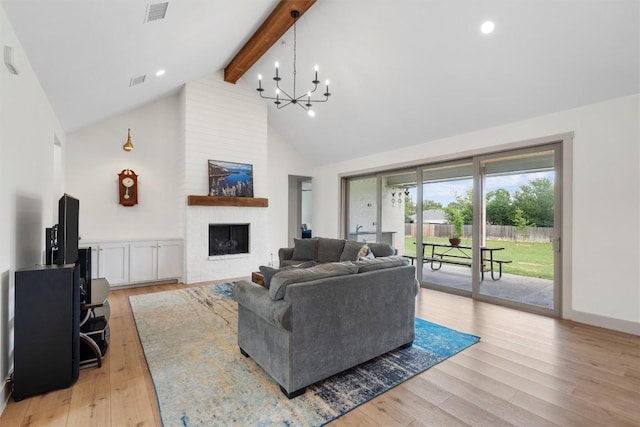 332 Claremont Dr, Belton, TX 76513 - living room with beamed ceiling, a chandelier, high vaulted ceiling, a fireplace, and light wood finished floors