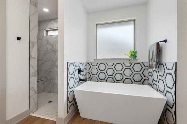 332 Claremont Dr, Belton, TX 76513 - full bath featuring wood finished floors, tile walls, a tile shower, a freestanding tub, and baseboards
