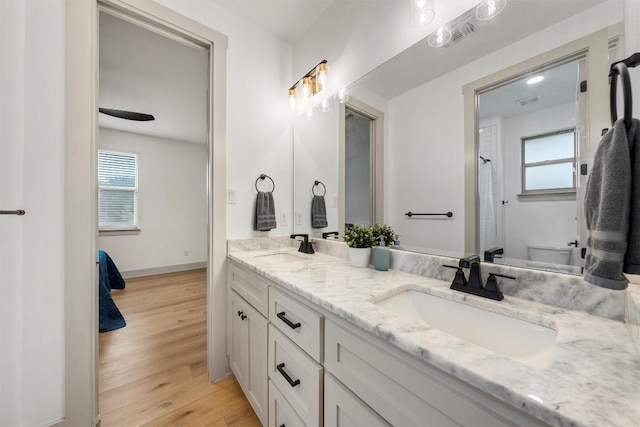 332 Claremont Dr, Belton, TX 76513 - full bathroom with double vanity, wood finished floors, baseboards, and a shower