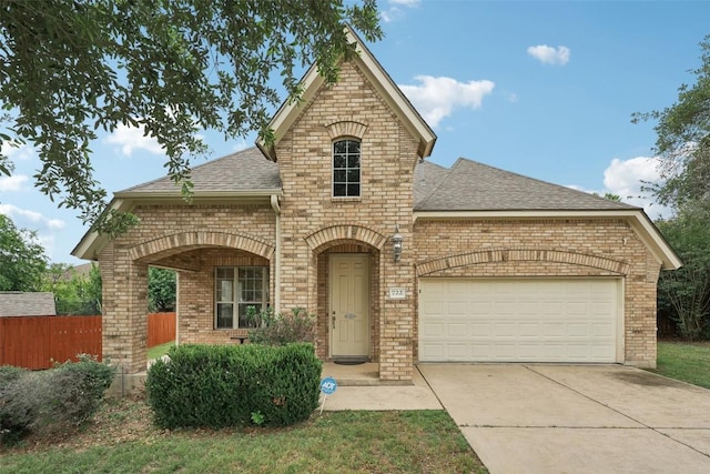 722 Tom Kite Dr, Round Rock, TX 78664 - french provincial home with brick siding, roof with shingles, concrete driveway, and an attached garage