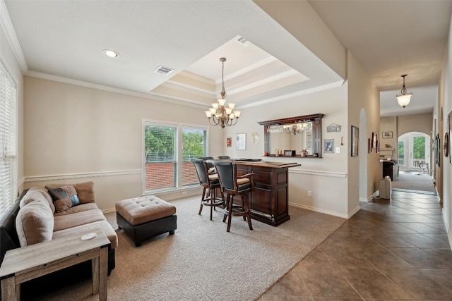 722 Tom Kite Dr, Round Rock, TX 78664 - tiled living room featuring arched walkways, plenty of natural light, ornamental molding, a chandelier, and a raised ceiling
