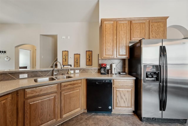 722 Tom Kite Dr, Round Rock, TX 78664 - kitchen featuring stainless steel fridge with ice dispenser, black dishwasher, a sink, arched walkways, and tile patterned floors