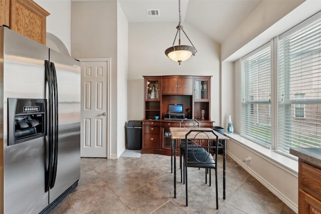 722 Tom Kite Dr, Round Rock, TX 78664 - dining space with an office area, light tile patterned flooring, high vaulted ceiling, and baseboards