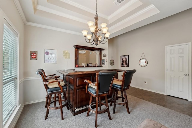 722 Tom Kite Dr, Round Rock, TX 78664 - indoor dry bar featuring a tray ceiling, ornamental molding, a chandelier, carpet flooring, and hanging light fixtures
