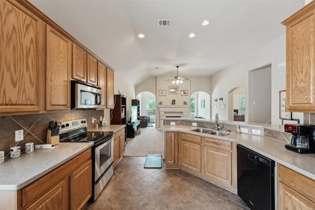 722 Tom Kite Dr, Round Rock, TX 78664 - kitchen featuring appliances with stainless steel finishes, arched walkways, a sink, a ceiling fan, and tile patterned floors