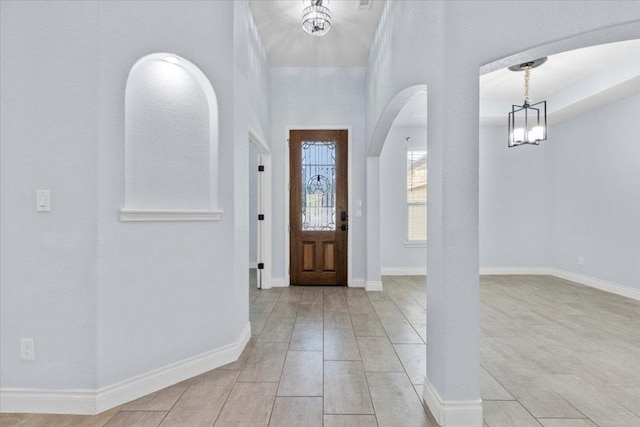 127 Medlar Dr, Cedar Creek, TX 78612 - entrance foyer with arched walkways, a chandelier, and a towering ceiling