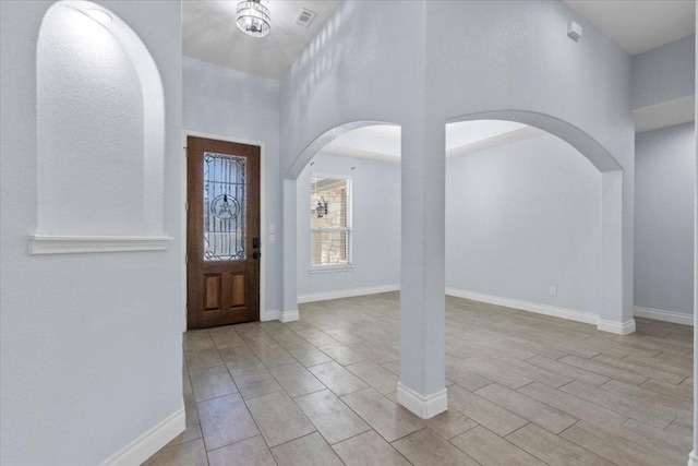 127 Medlar Dr, Cedar Creek, TX 78612 - entrance foyer featuring arched walkways, a towering ceiling, and baseboards