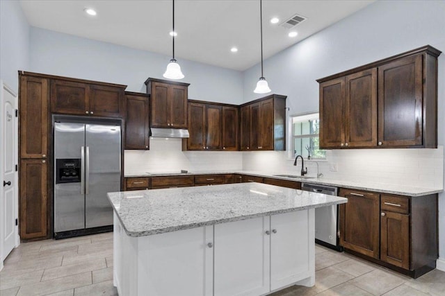 127 Medlar Dr, Cedar Creek, TX 78612 - kitchen with appliances with stainless steel finishes, a sink, dark brown cabinetry, tasteful backsplash, and light stone countertops