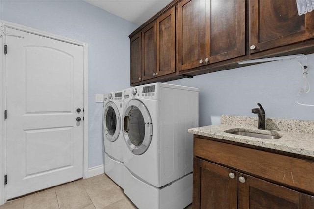127 Medlar Dr, Cedar Creek, TX 78612 - washroom with washer and dryer, cabinet space, light tile patterned flooring, and baseboards