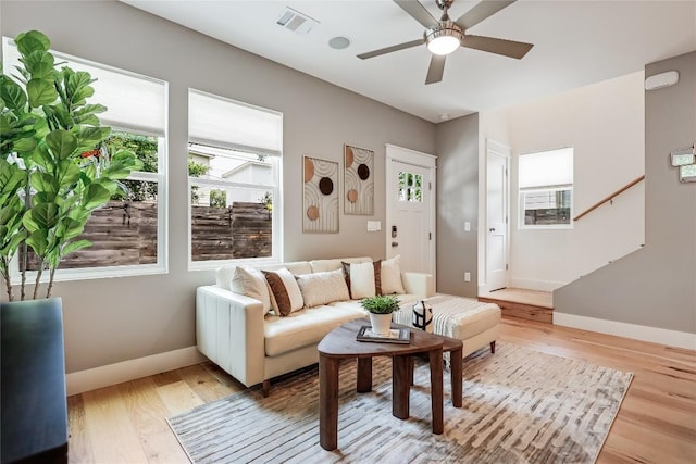 5512 Duval St Unit 2, Austin, TX 78751 - living room with baseboards, light wood-style flooring, ceiling fan, and stairs