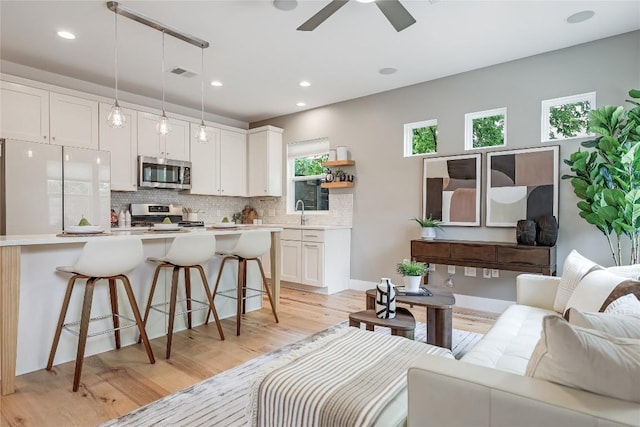 5512 Duval St Unit 2, Austin, TX 78751 - living area featuring light wood-type flooring, ceiling fan, and recessed lighting