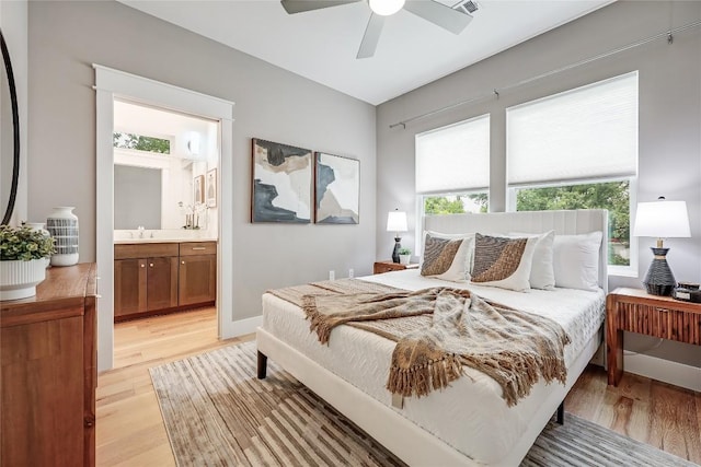 5512 Duval St Unit 2, Austin, TX 78751 - bedroom featuring light wood finished floors, multiple windows, and ensuite bath