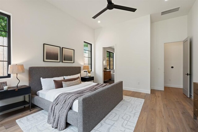 5218 Valley Oak Dr, Austin, TX 78731 - bedroom with multiple windows, light wood finished floors, recessed lighting, a high ceiling, and ceiling fan