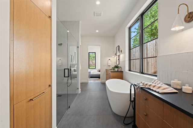5218 Valley Oak Dr, Austin, TX 78731 - bathroom featuring vanity, a shower stall, plenty of natural light, a soaking tub, and recessed lighting