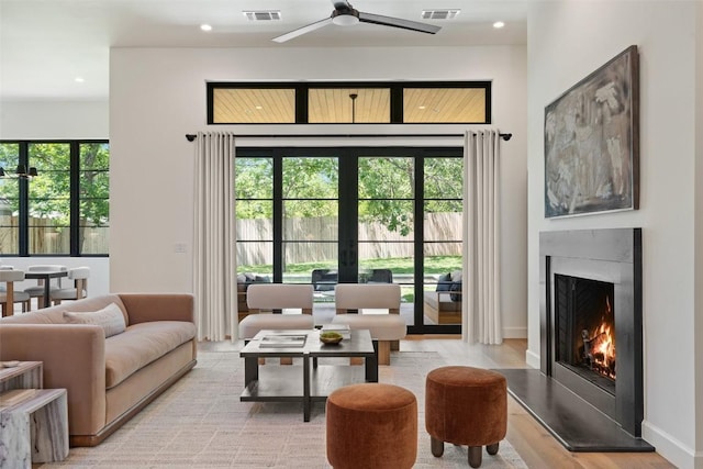 5218 Valley Oak Dr, Austin, TX 78731 - living room featuring healthy amount of natural light, a ceiling fan, a fireplace, recessed lighting, and french doors