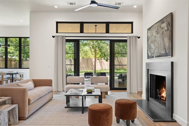 5218 Valley Oak Dr, Austin, TX 78731 - living area featuring ceiling fan, plenty of natural light, recessed lighting, a premium fireplace, and light wood-type flooring