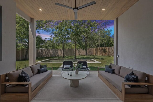 5218 Valley Oak Dr, Austin, TX 78731 - patio terrace at dusk with an outdoor hangout area, a fenced backyard, and ceiling fan