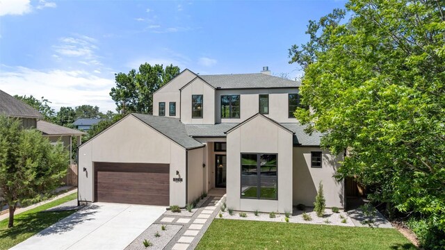 5218 Valley Oak Dr, Austin, TX 78731 - modern farmhouse style home with roof with shingles, a garage, driveway, stucco siding, and a front lawn