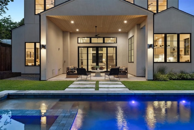 5218 Valley Oak Dr, Austin, TX 78731 - rear view of property featuring an outdoor hangout area, a ceiling fan, a patio area, stucco siding, and a pool with connected hot tub