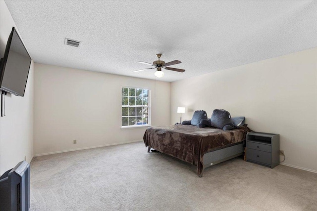 601 Wagon Wheel Trl, Pflugerville, TX 78660 - bedroom featuring light colored carpet, a textured ceiling, and a ceiling fan