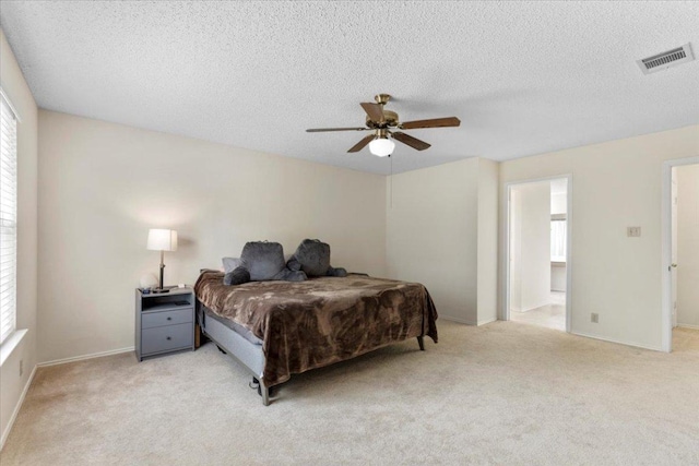 601 Wagon Wheel Trl, Pflugerville, TX 78660 - bedroom featuring multiple windows, light colored carpet, a textured ceiling, and ceiling fan