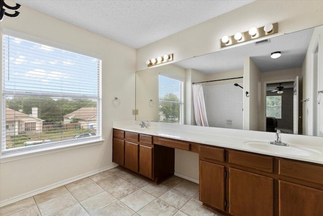 601 Wagon Wheel Trl, Pflugerville, TX 78660 - bathroom featuring double vanity, a ceiling fan, a textured ceiling, curtained shower, and tile patterned flooring