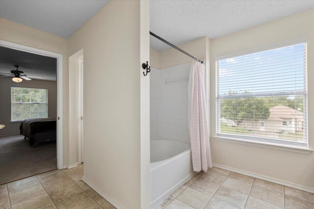 601 Wagon Wheel Trl, Pflugerville, TX 78660 - bathroom with ensuite bath, a textured ceiling, shower / bath combo, ceiling fan, and baseboards