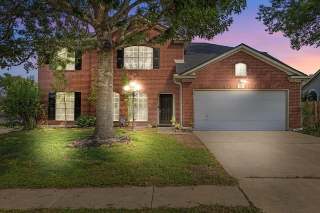 601 Wagon Wheel Trl, Pflugerville, TX 78660 - view of front of home featuring an attached garage, concrete driveway, a front yard, and brick siding