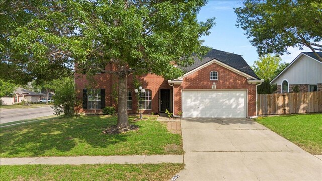 601 Wagon Wheel Trl, Pflugerville, TX 78660 - view of front of home with a garage, driveway, and brick siding