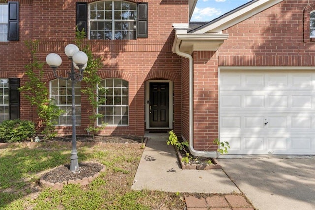 601 Wagon Wheel Trl, Pflugerville, TX 78660 - doorway to property featuring an attached garage and brick siding