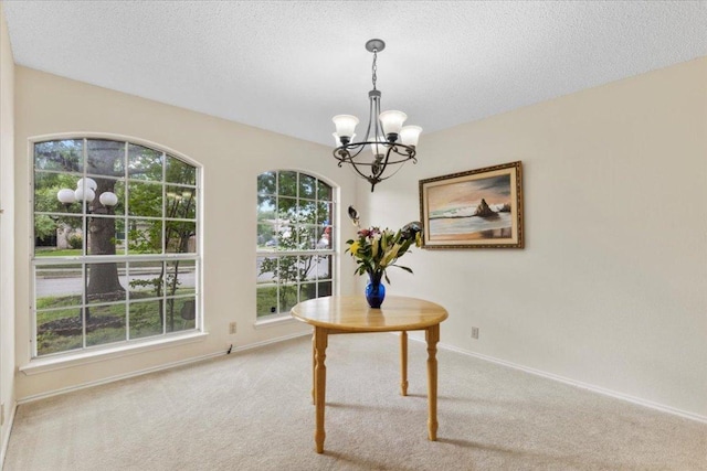 601 Wagon Wheel Trl, Pflugerville, TX 78660 - dining area featuring a chandelier, light colored carpet, healthy amount of natural light, baseboards, and a textured ceiling
