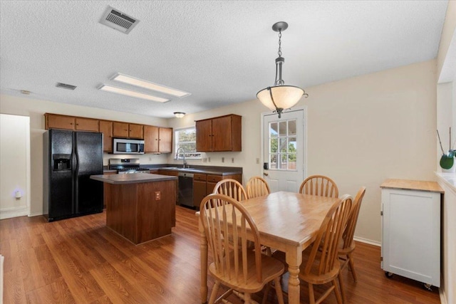 601 Wagon Wheel Trl, Pflugerville, TX 78660 - dining space with dark wood-style flooring and a textured ceiling