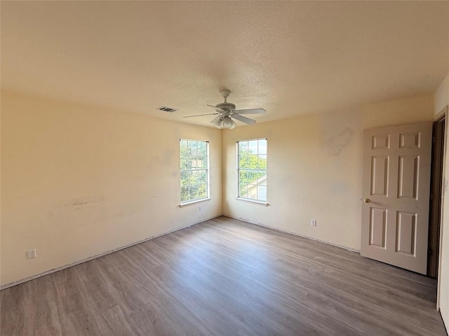 14604 Ballyclarc Dr, Austin, TX 78717 - unfurnished room featuring a ceiling fan, wood finished floors, and a textured ceiling