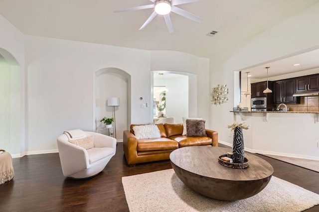 4349 Green Tree Dr, Round Rock, TX 78665 - living area featuring a ceiling fan, arched walkways, dark wood-type flooring, and baseboards