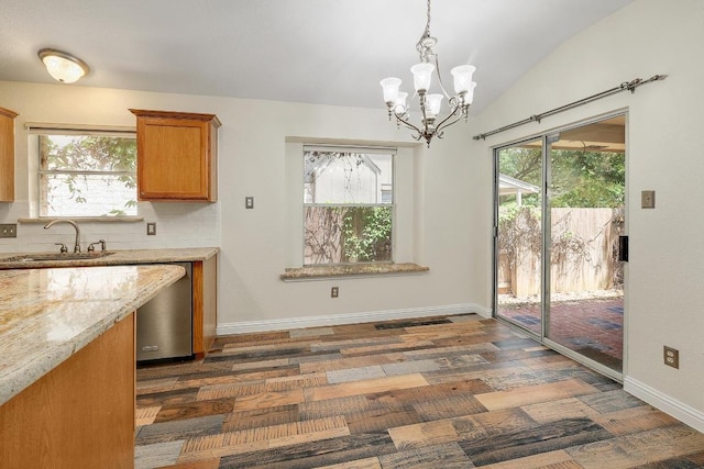700 Horizon Trl, Cedar Park, TX 78613 - kitchen featuring stainless steel dishwasher, a chandelier, dark wood-type flooring, brown cabinetry, and healthy amount of natural light