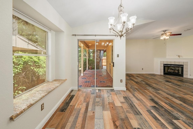 700 Horizon Trl, Cedar Park, TX 78613 - unfurnished living room featuring wood finished floors, a fireplace, a chandelier, lofted ceiling, and a ceiling fan