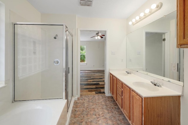 700 Horizon Trl, Cedar Park, TX 78613 - full bathroom with double vanity, a shower stall, a garden tub, and a ceiling fan