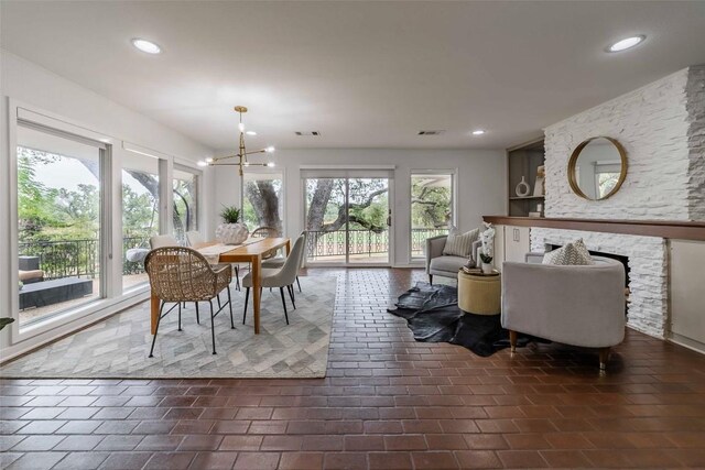 928 Porpoise St, Lakeway, TX 78734 - dining space featuring a chandelier, a fireplace, and recessed lighting