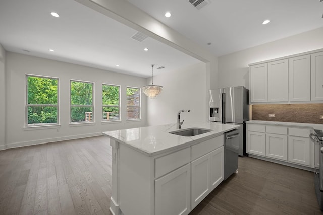 13501 Metric Blvd Unit 22, Austin, TX 78727 - kitchen with a sink, stainless steel appliances, wood finished floors, tasteful backsplash, and light stone countertops