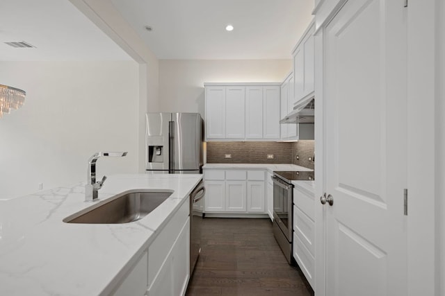 13501 Metric Blvd Unit 22, Austin, TX 78727 - kitchen with stainless steel appliances, a sink, tasteful backsplash, under cabinet range hood, and light stone countertops