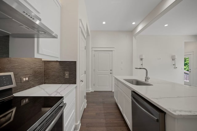 13501 Metric Blvd Unit 22, Austin, TX 78727 - kitchen featuring stainless steel appliances, wall chimney exhaust hood, a sink, white cabinetry, and tasteful backsplash