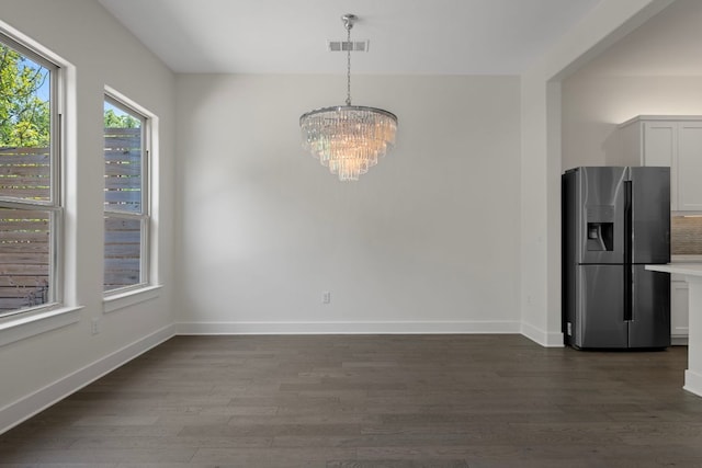 13501 Metric Blvd Unit 22, Austin, TX 78727 - unfurnished dining area with a chandelier, dark wood finished floors, and baseboards